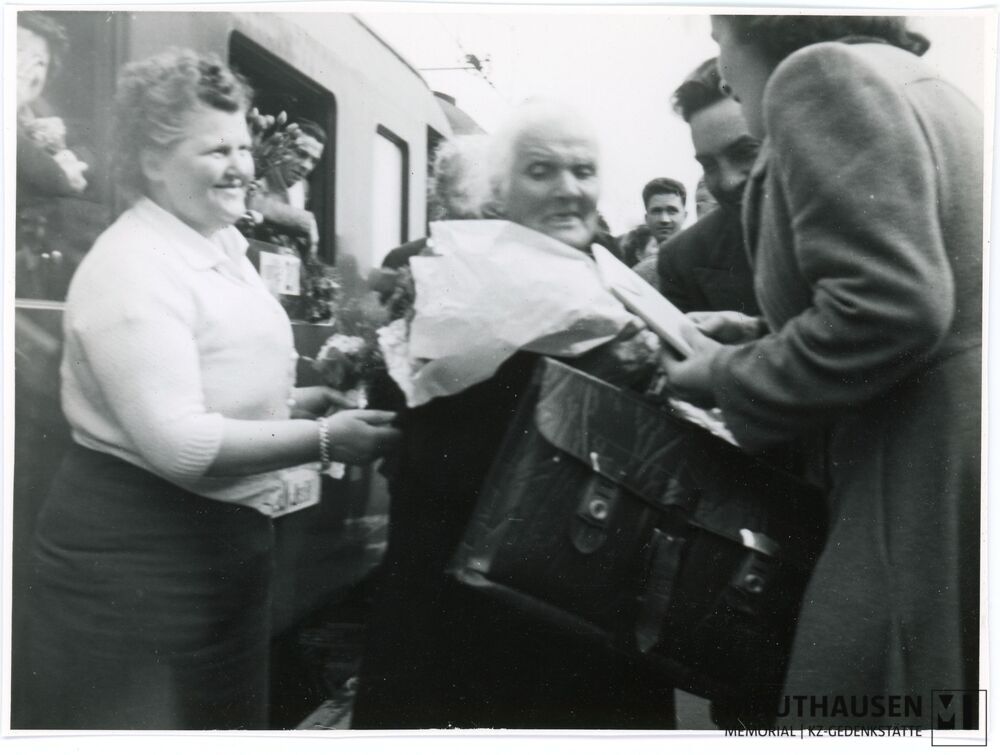 4.16.0024.jpg; 4.16.0024; Begrüßung/Abschied am Bahnhof. Madame Bunel nimmt Blumen entgegen, rechts neben ihr steht Emile Valley;